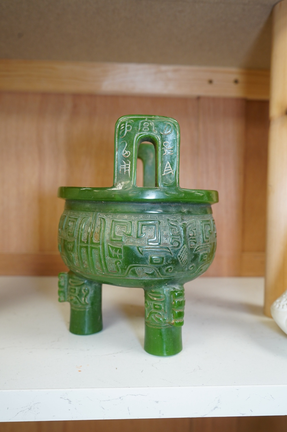 A Chinese green glass tripod censer, 20cm high. Condition - fair